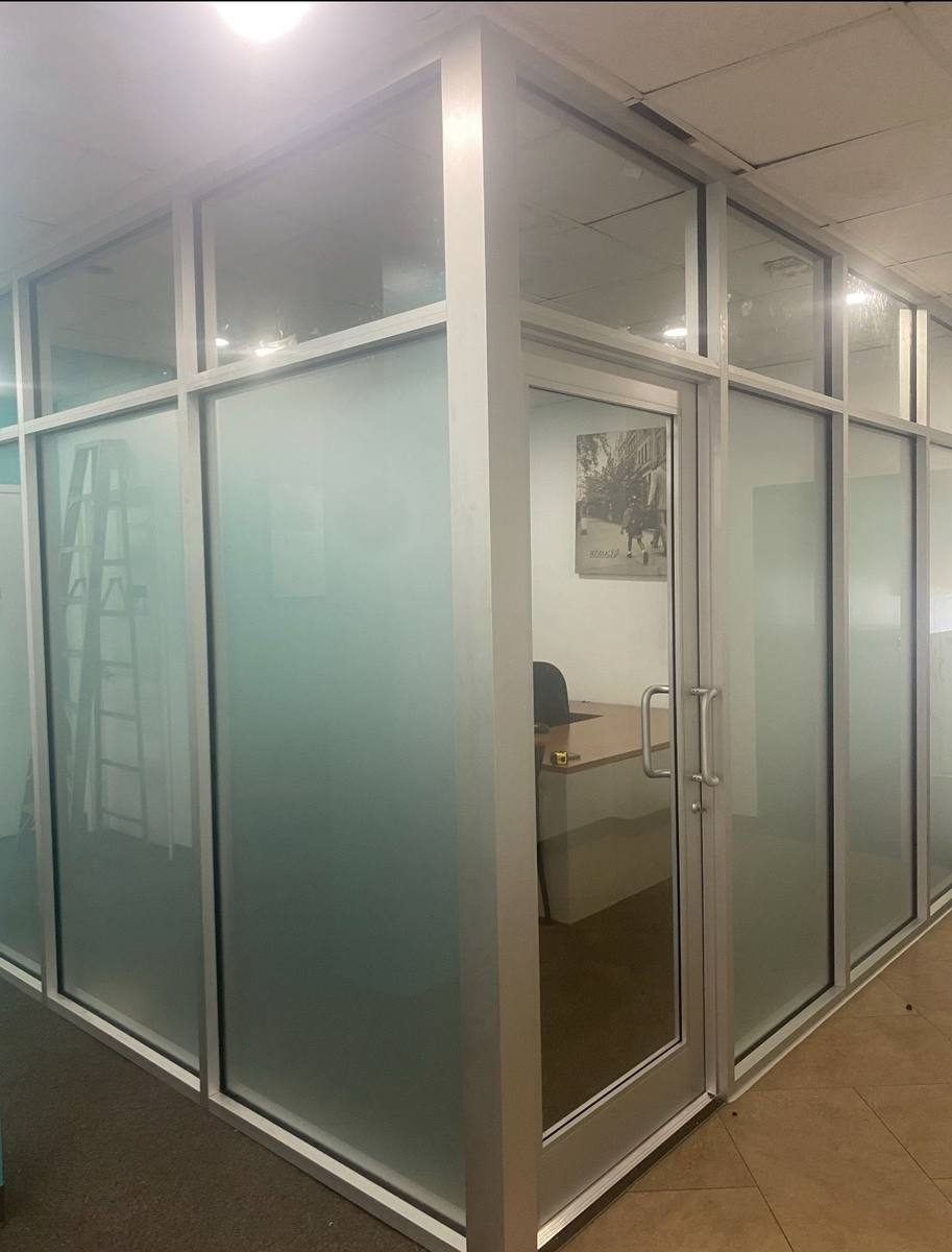 Glass office partitions with frosted privacy panels