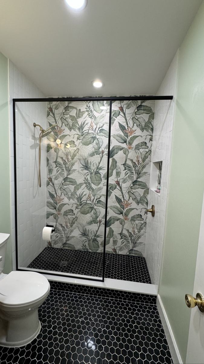 Glass shower enclosure with matte black frame