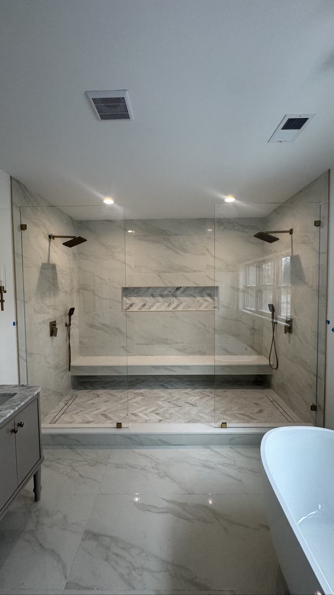 Frameless splashguard panels with brushed bronze hardware